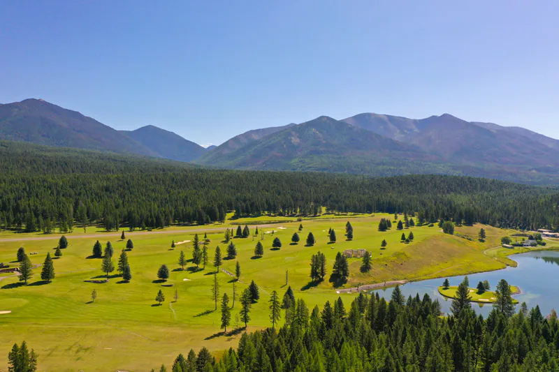 The view from the deck of a Built Right home: pine meadow, water and the mountains beyond
